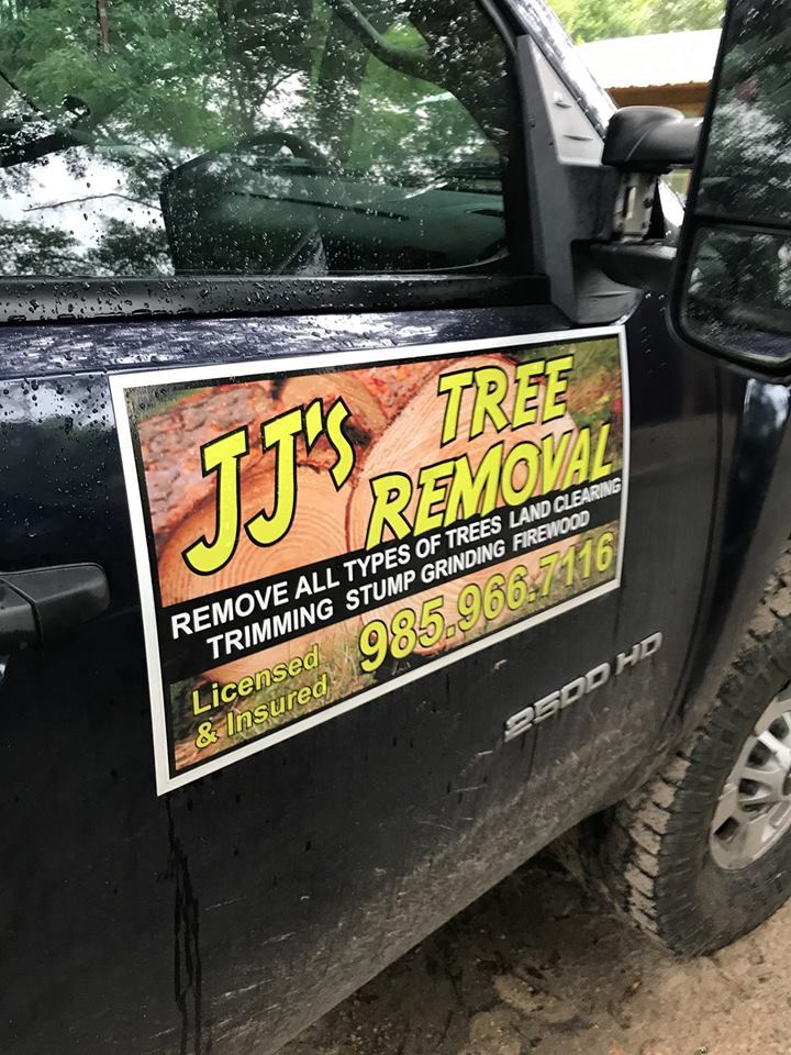 JJ's Tree Removal work truck with the magnetic service sign