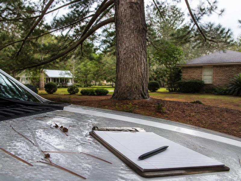 Clipboard on a truck hood facing a pine